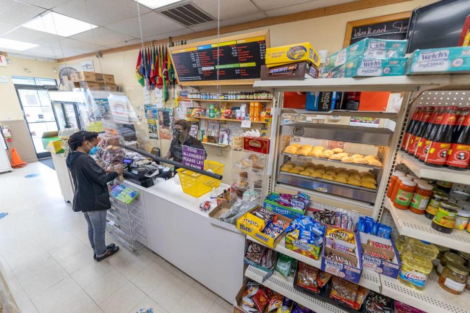 Abigail Coke checks out a customer at Island Grocery.