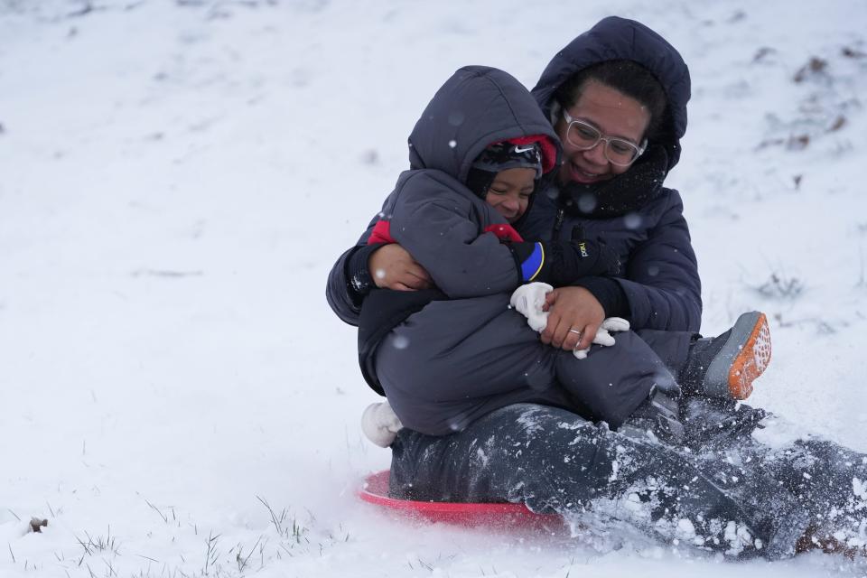 Luka Lalanne, left, sleds down a hill with his mother, Alyssa, at Scioto Audubon Metro Park after an overnight snowstorm in this January file photo.