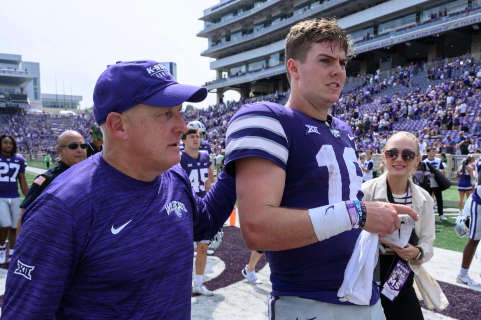 Kansas State head coach Chris Klieman, left, walks off the field with Kansas State quarterback Will Howard (18) after their win over Troy in an NCAA college football game in Manhattan, Kan., Saturday, Sept. 9, 2023. (AP Photo/Reed Hoffmann)