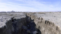 This frame grab from video taken on Jan. 8, 2019, shows fissure in the land caused by drought and excessive water pumping, in Malard, west of Tehran, Iran. Fissures appear along roads, while massive holes open up in the countryside, their gaping maws a visible sign from the air of something Iranian authorities now openly acknowledge: The area around the capital Tehran is literally sinking. (AP Photo)