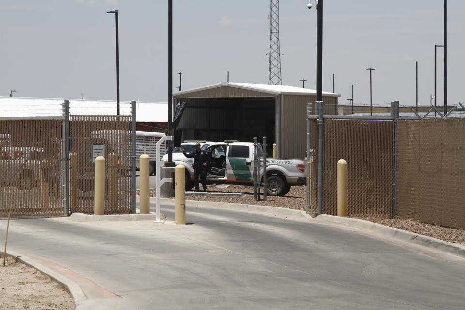 A Customs and Border Patrol officer guards the entrance to the Border Patrol station in Clint, Texas, Wednesday, June 26, 2019. The facility has been a hub for detained children in border patrol custody in New Mexico and West Texas since 2014. (AP Photo/Cedar Attanasio)