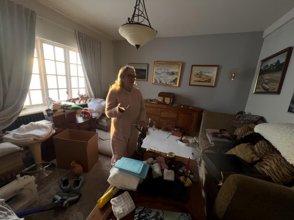 A resident in her living room of a house sitting on fault line damaged by earthquakes in Grindavik sorting through her possessions (Getty Images)