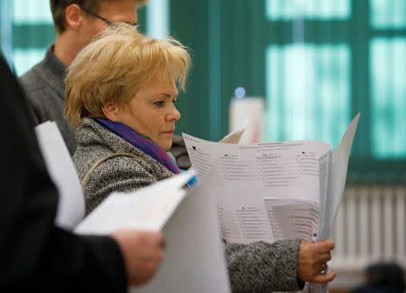 A woman attends the Polish regional elections, at a polling station in Warsaw, Poland, October 21, 2018. REUTERS/Kacper Pempel