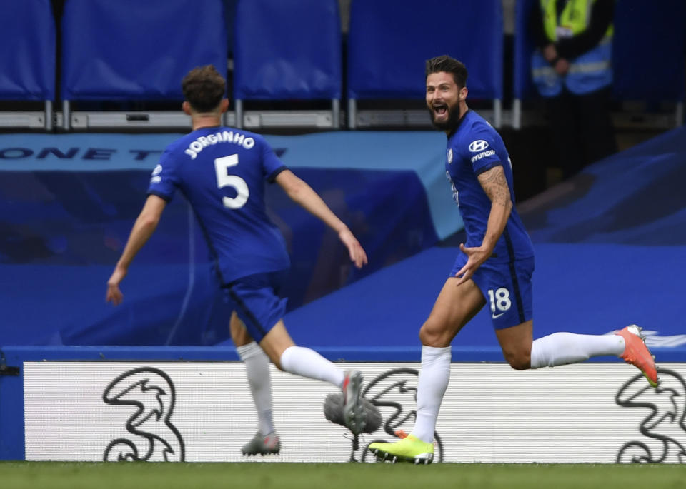 Chelsea's Olivier Giroud, right, celebrates with teammate Jorginho after scoring his sides second goal during the English Premier League soccer match between Chelsea and Wolverhampton Wanderers at Stamford Bridge, in London, Sunday July 26, 2020. (Mike Hewitt/Pool via AP)