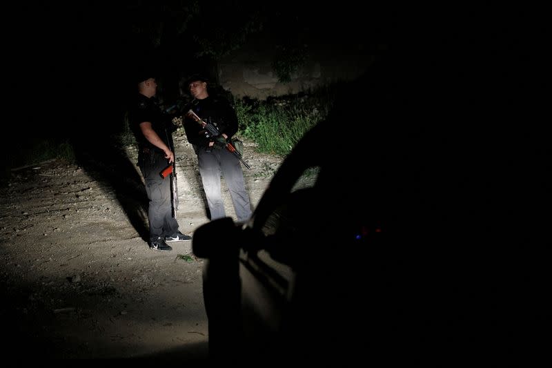 Ukrainian police officers patrol the city of Kramatorsk at night time