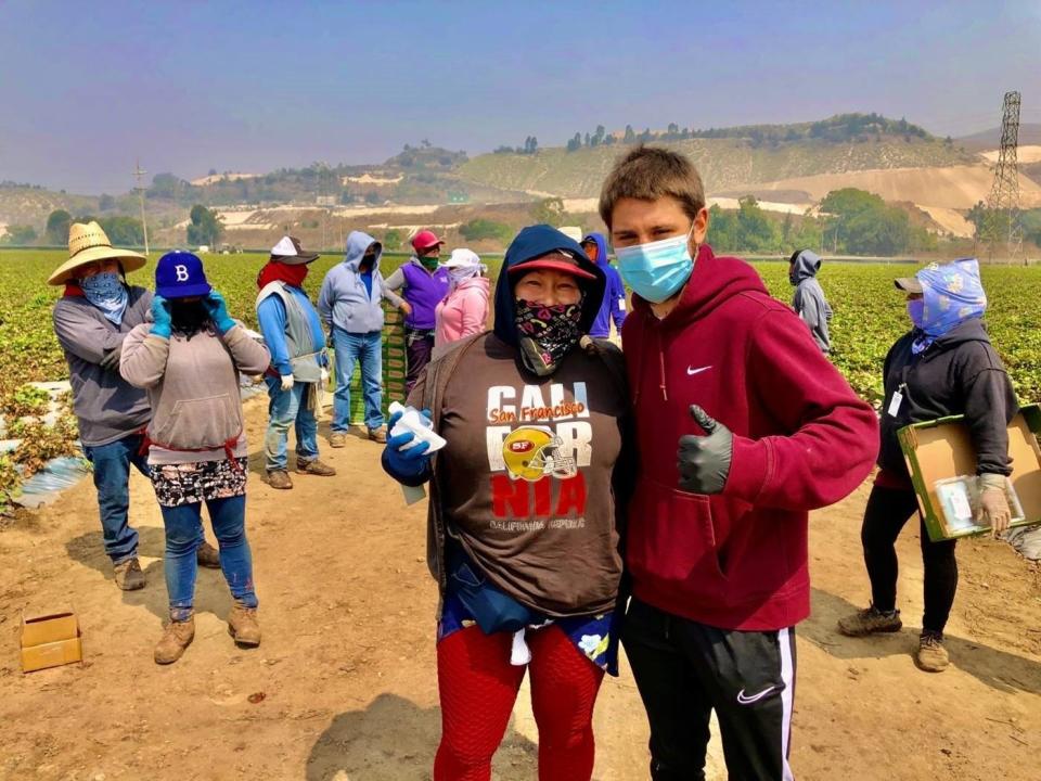 As wildfires burned throughout California during the COVID-19 pandemic in October 2020, Ruben Villa IV, right, donated masks and hand sanitizer to local farmworkers.