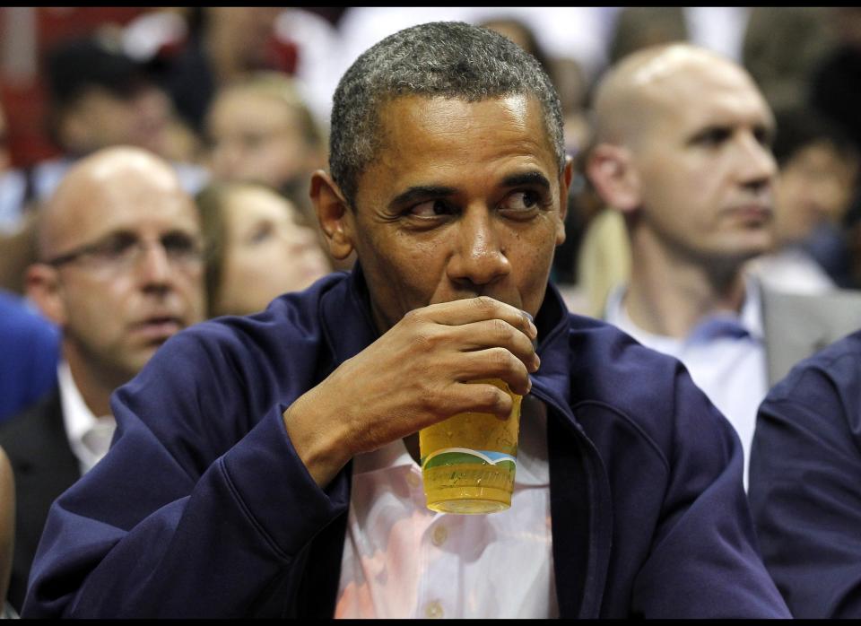 In this July 16, 2012 file photo, Obama sips his beer as he watches Team USA and Brazil during the first half of an Olympic men's exhibition basketball game, in Washington. (AP Photo/Alex Brandon, File)