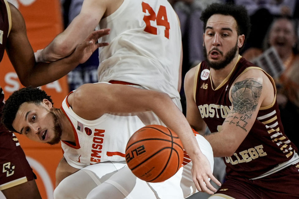 Clemson guard Chase Hunter (1) and Boston College guard Jaeden Zackery (3) vie for a loose ball during the second half of an NCAA college basketball game, Saturday, Jan. 13, 2024, in Clemson, S.C. (AP Photo/Mike Stewart)