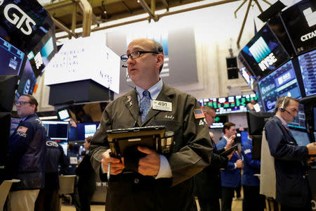 FILE PHOTO: Traders work on the floor of the New York Stock Exchange (NYSE) in New York, U.S., April 18, 2018. REUTERS/Brendan McDermid/File Photo