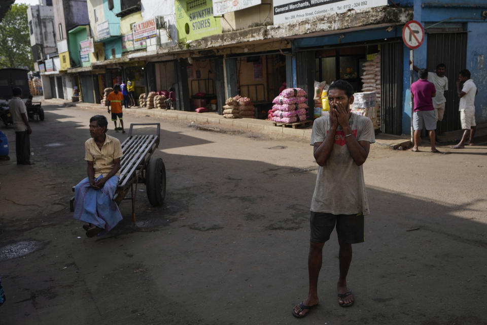 Laborers wait to find work at a wholesale market in Colombo, Sri Lanka, Sunday, June 26, 2022. Sri Lankans have endured months of shortages of food, fuel and other necessities due to the country's dwindling foreign exchange reserves and mounting debt, worsened by the pandemic and other longer term troubles. (AP Photo/Eranga Jayawardena)