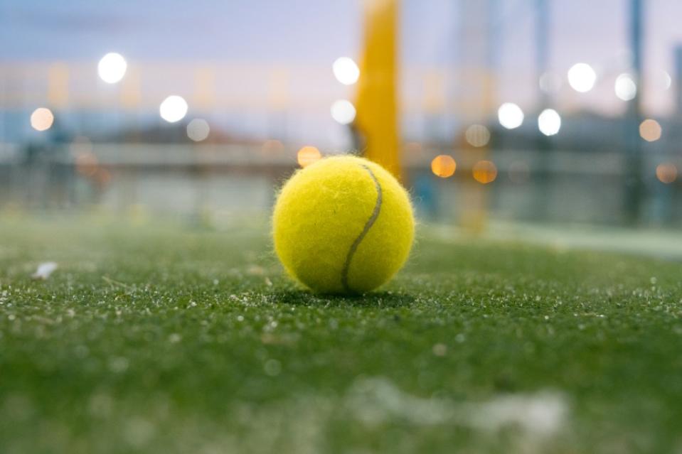 Paddle tennis ball on field at night via Getty Images