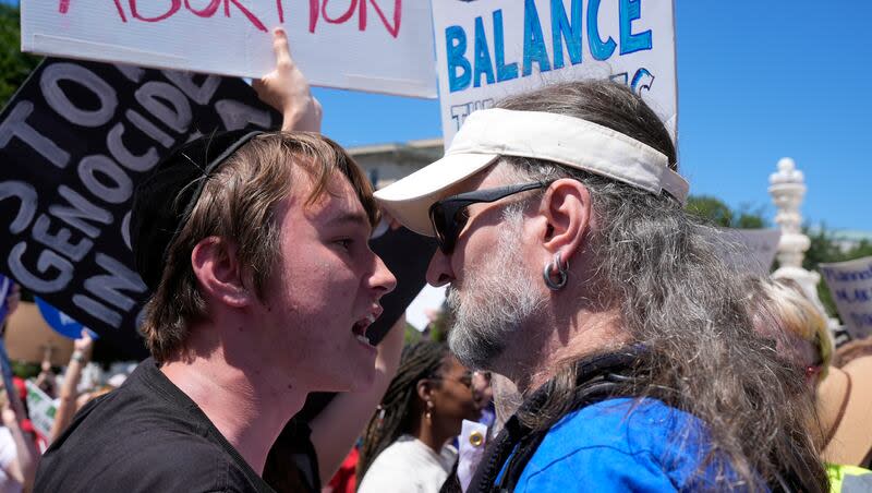 An anti-abortion demonstrator, left, and a abortion rights activist, right, protest outside the Supreme Court, Monday, June 24, 2024, in Washington.