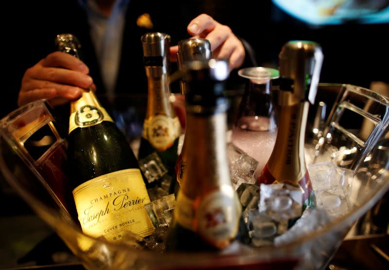 FILE PHOTO: A bartender serves a flute of champagne at Goss, a champagne bar, at Ginza shopping district in Tokyo