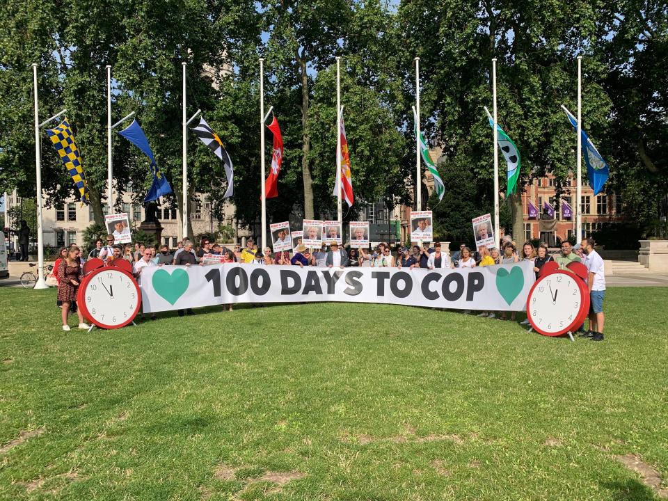 Climate campaigners gather in Parliament Square, behind a giant banner calling for action 100 days before the Cop26 summit (Sam Hancock)