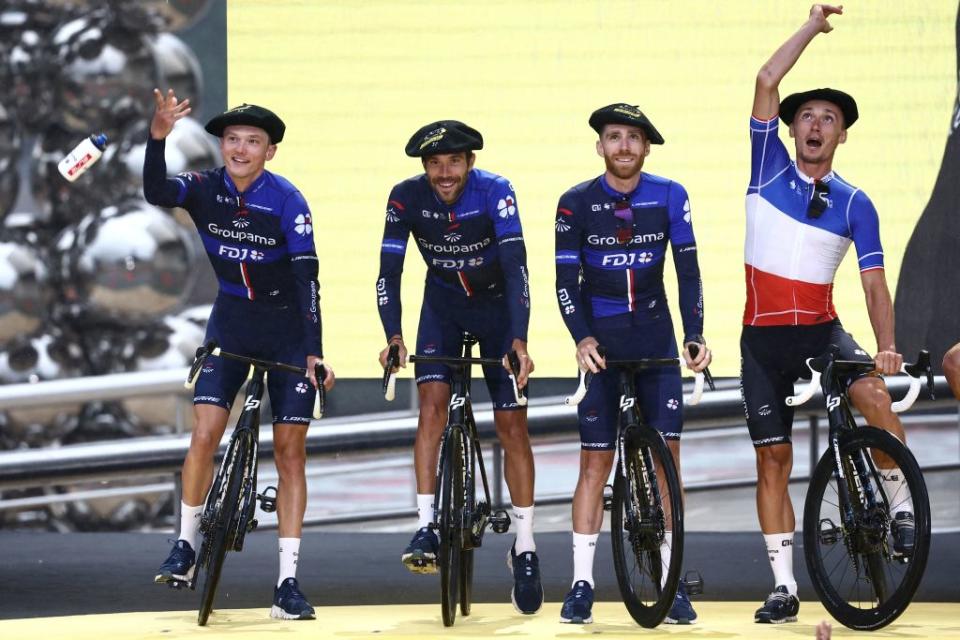 Groupama  FDJs French rider David Gaudu R and teammates toss water bottles to spectators from the stage during the official teams presentation near the Guggenheim Museum Bilbao in Bilbao northern Spain on June 29 2023 two days prior to the start of the 110th edition of the Tour de France cycling race Photo by AnneChristine POUJOULAT  AFP Photo by ANNECHRISTINE POUJOULATAFP via Getty Images