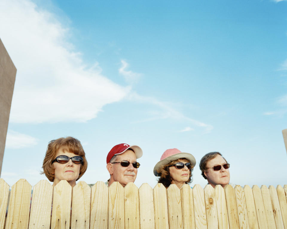 People being nosy looking over a fence