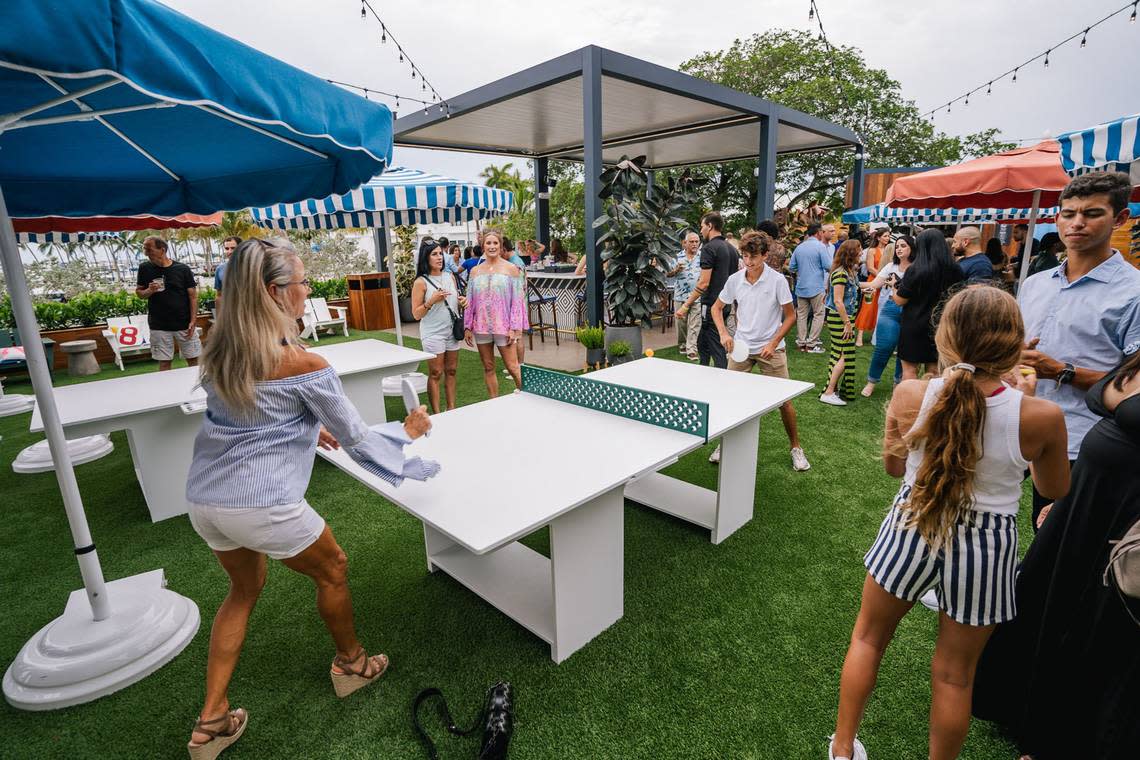 A ping pong game breaks out at the opening party for Regatta Grove, the new outdoor entertainment venue in Coconut Grove.