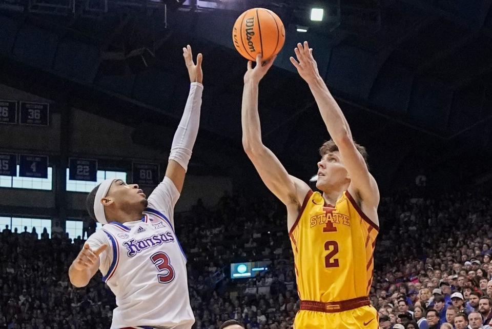 Iowa State guard Caleb Grill, right, shoots a 3-point basket as Kansas Jayhawks guard Dajuan Harris Jr. defends during the first half, Jan. 14, 2023, at Allen Fieldhouse in Lawrence, Kan.