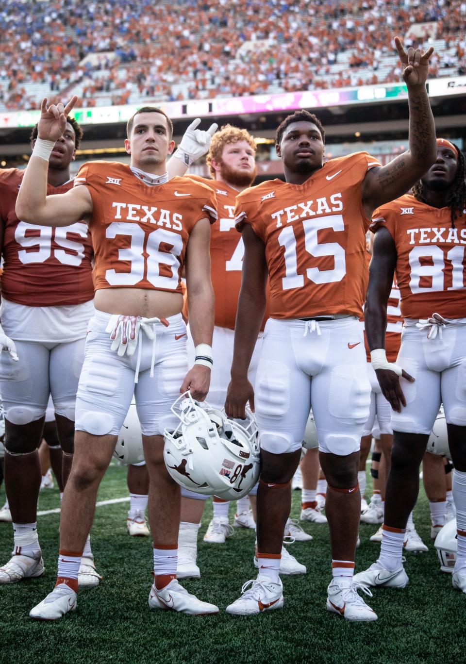 Texas defensive back Graham Gillespie (38) and linebacker S'Maje Burrell (15) put their "Horns Up" for "The Eyes of Texas" after the Longhorns' game against the BYU Cougars at Darrell K Royal-Texas Memorial Stadium in Austin on Oct. 28, 2023. Texas won the game 35-6.