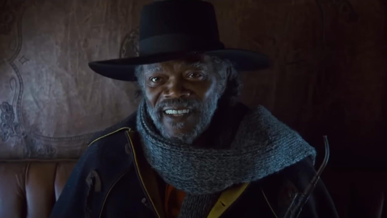  Samuel L Jackson sits smiling in a stagecoach in The Hateful Eight. 