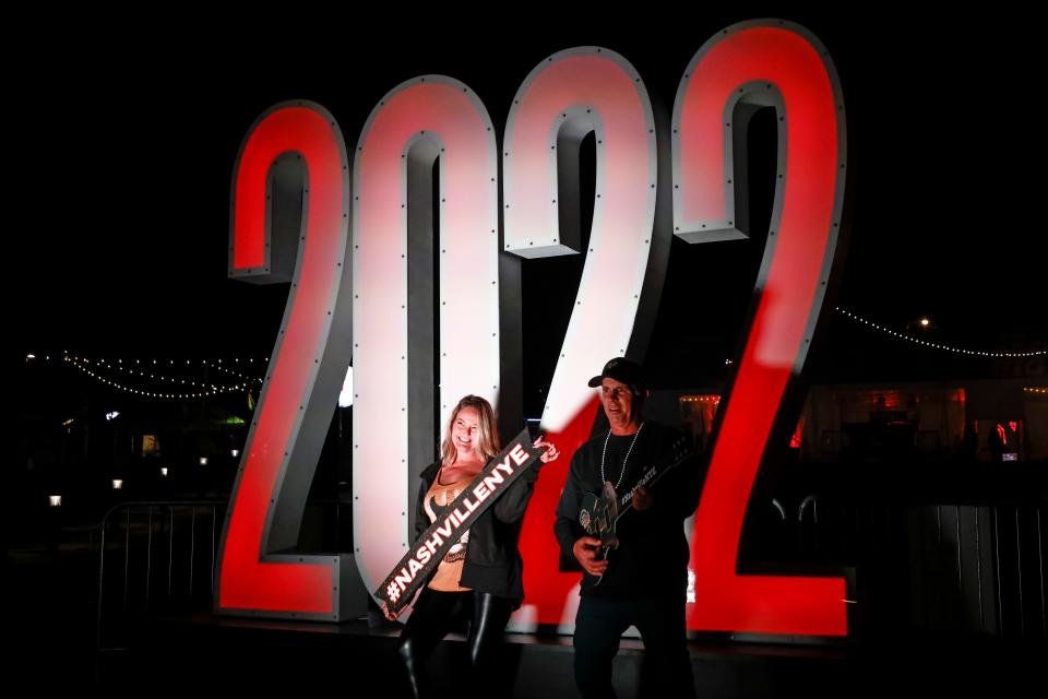 A couple has their photo taken at the 2022 sign during the Jack DanielÕs Live New YearÕs Eve Nashville Big Bash at Bicentennial Capitol Mall State Park, Friday, Dec. 31, 2021, in Nashville, Tenn. 