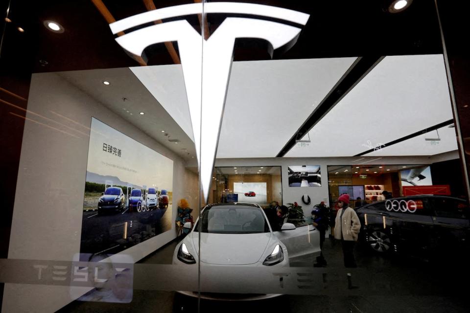 FILE PHOTO: FILE PHOTO: Visitors check a Tesla Model 3 car next to a Model Y displayed at a showroom of the U.S. electric vehicle (EV) maker in Beijing, China February 4, 2023. REUTERS/Florence Lo/File Photo/File Photo