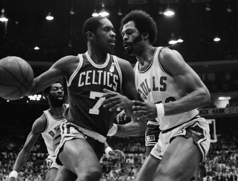 Nate Archibald (7) of the Boston Celtics moves past Artis Gilmore (53) of the <a class="link " href="https://sports.yahoo.com/nba/teams/chicago/" data-i13n="sec:content-canvas;subsec:anchor_text;elm:context_link" data-ylk="slk:Chicago Bulls;sec:content-canvas;subsec:anchor_text;elm:context_link;itc:0">Chicago Bulls</a> in NBA playoff action in Chicago, Ill., April 12, 1981. The Bulls’ Bobby Wilkerson (330 is in the background. (AP Photo/Fred Jewell)