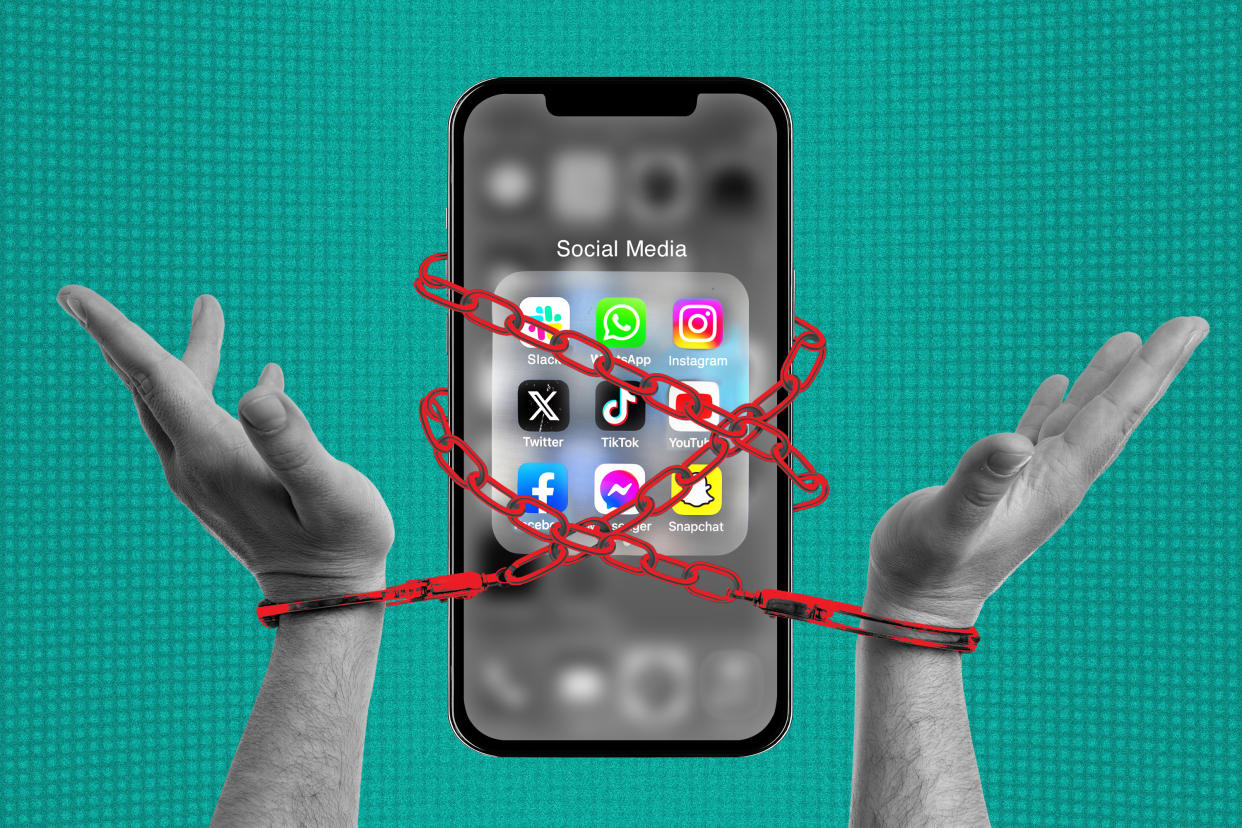 A photo illustration of two hands chained to a cellphone showing social media apps