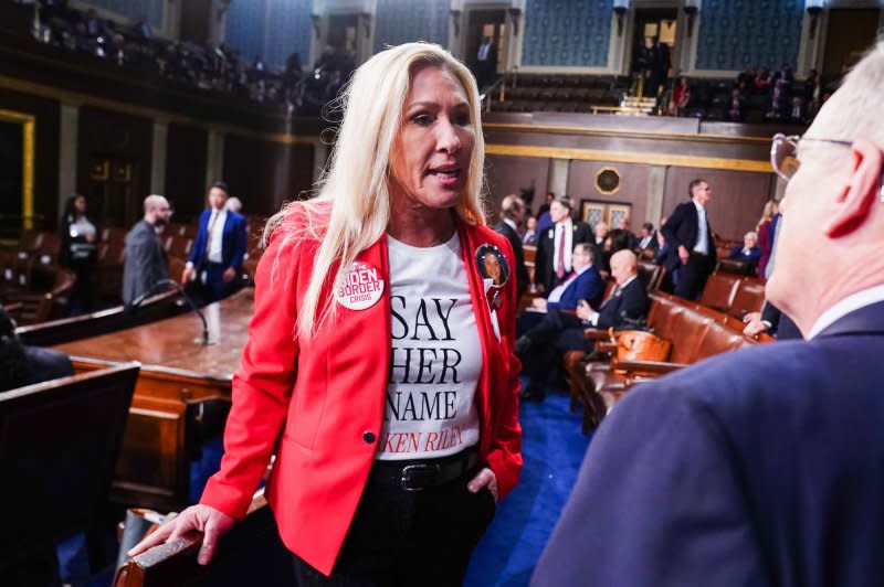 Rep. Marjorie Taylor Greene, R-Ga., talks to a colleague as she waits for President Joe Biden to deliver the annual State of the Union speech in Washington, D.C., on Thursday. Pool Photo by Shawn Thew/UPI