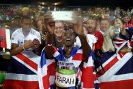 <p>Mohamed Farah of Great Britain takes a photo after winning gold in the Men’s 5000 meter Final on Day 15 of the Rio 2016 Olympic Games at the Olympic Stadium on August 20, 2016 in Rio de Janeiro, Brazil. (Photo by Patrick Smith/Getty Images) </p>