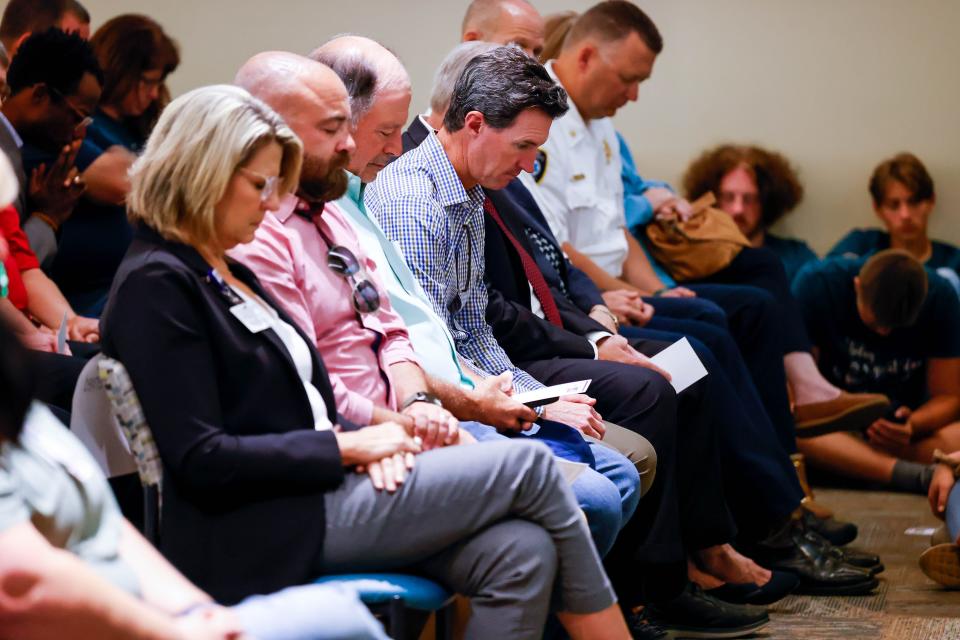 Attendees bow for a moment of silence Friday during a remembrance for the 10-year anniversary of the Moore tornado at Norman Regional Moore in Moore.