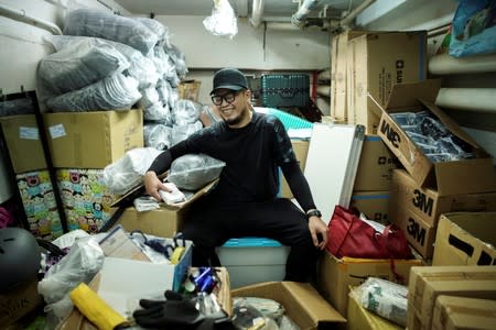 Keita Lee, 33, owner of the "National Calamity Hardware Store" poses at his shop in Hong Kong, China