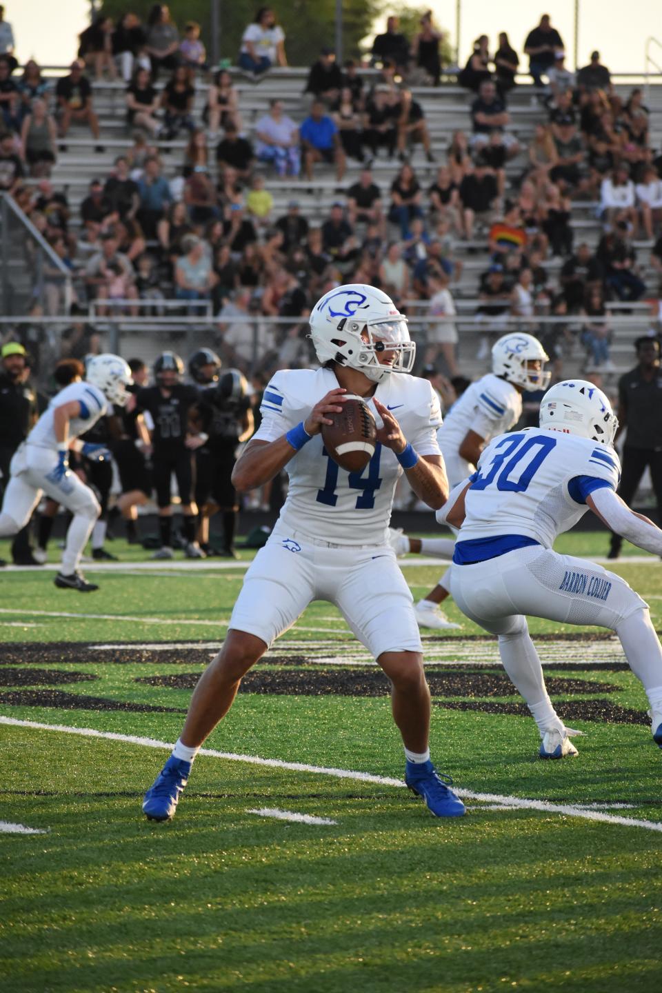 Barron Collier quarterback Niko Boyce looks to pass against Palmetto Ridge in high school football on Friday, Sept, 1, 2023. Barron Collier won 49-0.