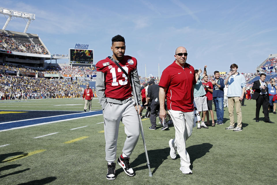 ORLANDO, FL - JANUARY 01: Injured quarterback Tua Tagovailoa #13 of the Alabama Crimson Tide leaves the field following warmups prior to the Vrbo Citrus Bowl against the Michigan Wolverines at Camping World Stadium on January 1, 2020 in Orlando, Florida. Alabama defeated Michigan 35-16. (Photo by Joe Robbins/Getty Images)