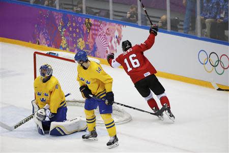 Canada's Toews scores on Sweden's goalie Lundqvist as Sweden's Berglund reacts during the first period of the men's ice hockey gold medal game at the 2014 Sochi Winter Olympic Games