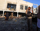<p>People inspect the aftermath of a Saudi-led coalition airstrike in Sanaa, Yemen, Saturday, Oct. 8, 2016. (AP Photo/Osamah Abdulrhman)</p>
