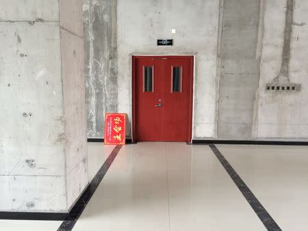 A door is seen at an empty area inside of Hongxiang Building, which houses an incubator for high-tech start-ups, in Shacheng, Hebei Province, China, May 11, 2016. REUTERS/Sue-Lin Wong