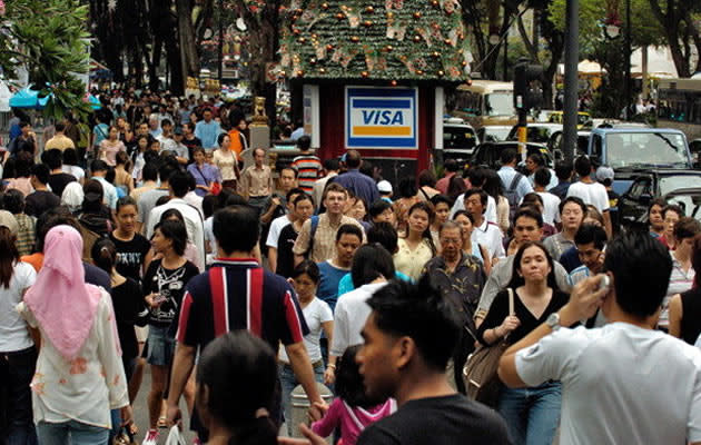 Getty Images - SINGAPORE - JANUARY 01: Singaporeans, tourists and expatriates crowd Orchard Road, the shopping mall-lined street in Singapore Saturday, January 1, 2005. (Photo by Munshi Ahmed/Bloomberg via Getty Images) less