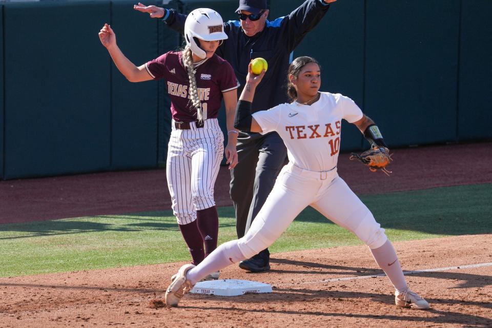Texas' Mia Scott looks to throw the ball after Texas State's Piper Randolph was ruled safe at third base during their April 10 game at McCombs Field. The Longhorns are battling Oklahoma and Oklahoma State for the Big 12 championship heading into the final three games of the regular season.