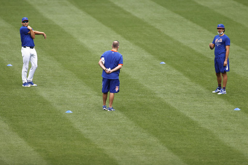 New York Mets pitchers Seth Lugo, left, and Daniel Zamora, right, stretch during a baseball workout at Citi Field in New York, Friday, July 3, 2020. (AP Photo/Adam Hunger)