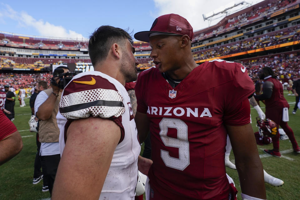 Washington Commanders quarterback Sam Howell (14) and Arizona Cardinals quarterback Joshua Dobbs (9) meet on the field after an NFL preseason football game, Sunday, Sept. 10, 2023, in Landover, Md. Washington won 20-6. (AP Photo/Alex Brandon)