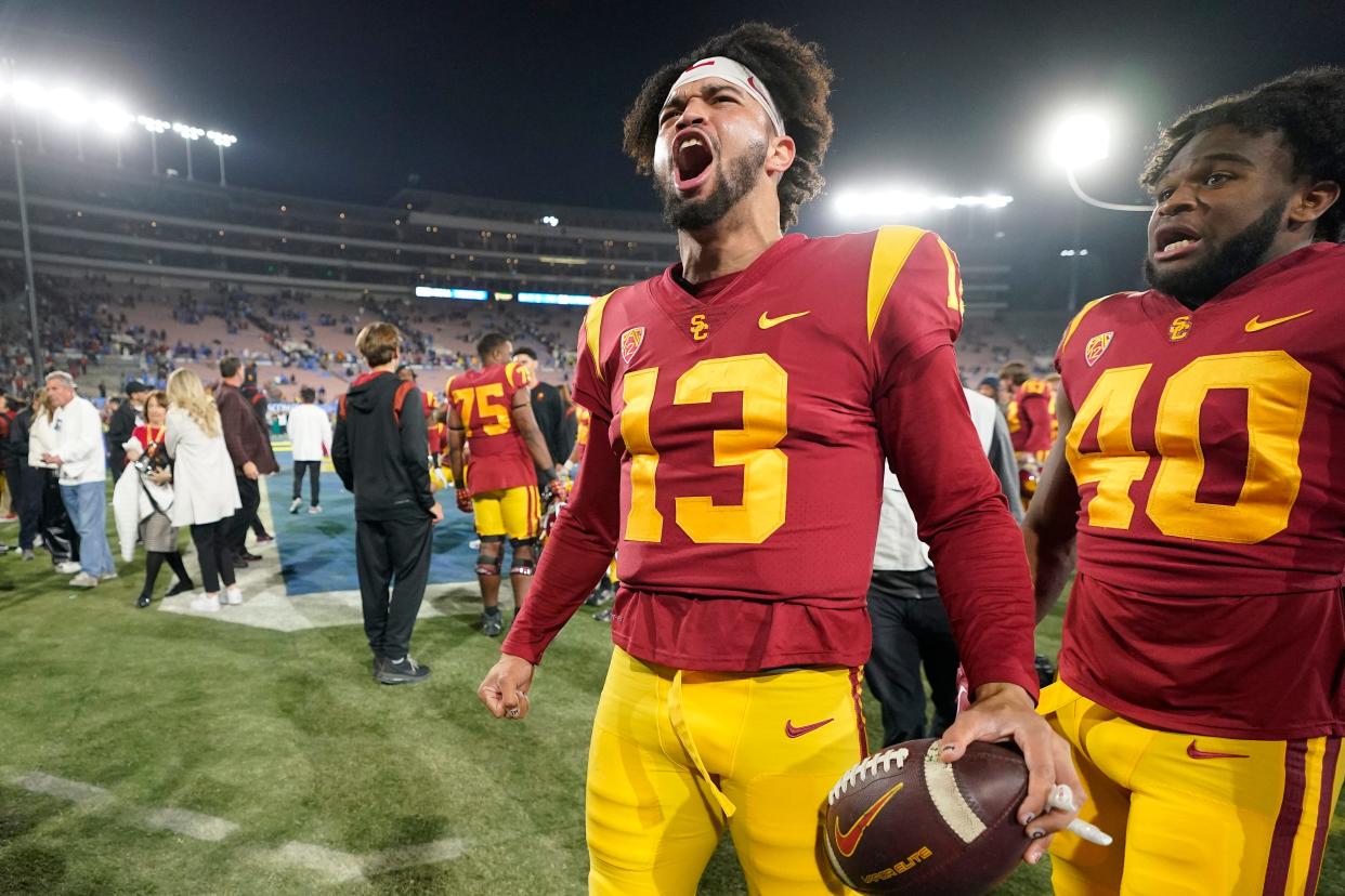 USC quarterback Caleb Williams, left, celebrates after USC defeated UCLA 48-45 in an NCAA college football game Saturday, Nov. 19, 2022, in Pasadena, Calif.