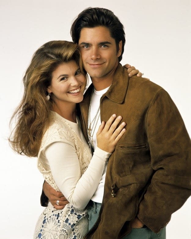 Lori Loughlin as Becky and John Stamos as Jesse pose for a "Full House" Season 7 promotional photo in August 1993