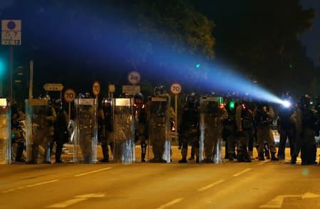 Riot police officers block the street during an anti-government protest in Tai Po district, in Hong Kong