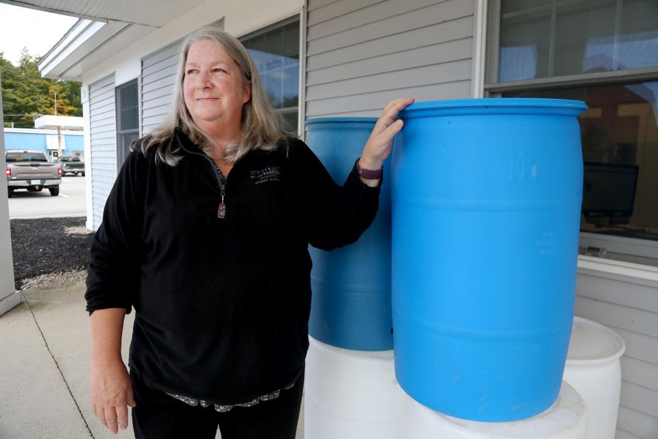 Jennifer Perry has been Exeter’s DPW director for 15 years. Perry stands near rainwater bins outside of the office on Tuesday, September 27, 2022 in Exeter. The rainwater bins are given to residents who donate non-perishable items to St. Vincent De Paul. 