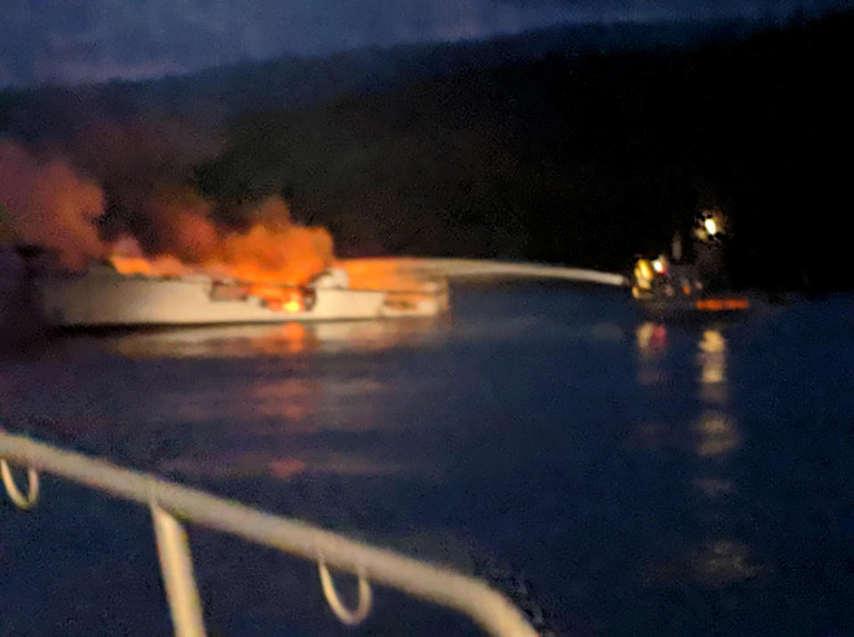 In this photo provided by the Santa Barbara County Fire Department, firefighters work to extinguish a dive boat engulfed in flames after a deadly fire broke out aboard the commercial scuba diving vessel off the Southern California Coast Monday morning, Sept. 2, 2019. (Santa Barbara County Fire Department via AP)