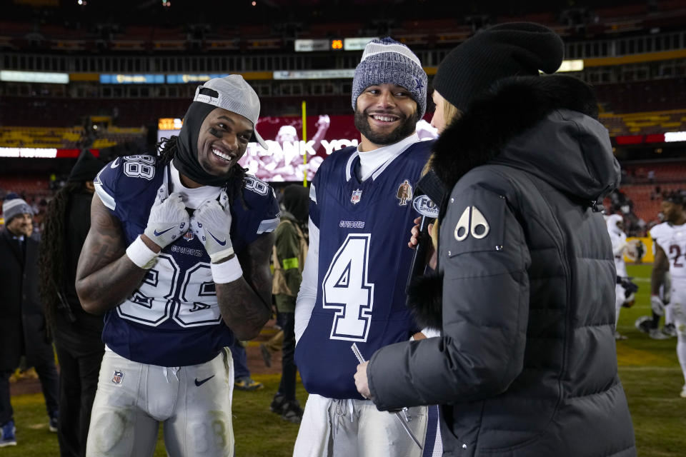 Dallas Cowboys wide receiver CeeDee Lamb (88) and quarterback Dak Prescott (4) smile as they are interviewed at the end of an NFL football game against the Washington Commanders, Sunday, Jan. 7, 2024, in Landover, Md. Dallas won 38-10. (AP Photo/Susan Walsh)