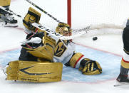 Vegas Golden Knights goaltender Marc-Andre Fleury lies on the ice with the puck in the net on a goal by Montreal Canadiens' Josh Anderson during overtime in Game 3 of an NHL hockey semifinal series, Friday, June 18, 2021, in Montreal. (Paul Chiasson/The Canadian Press via AP)