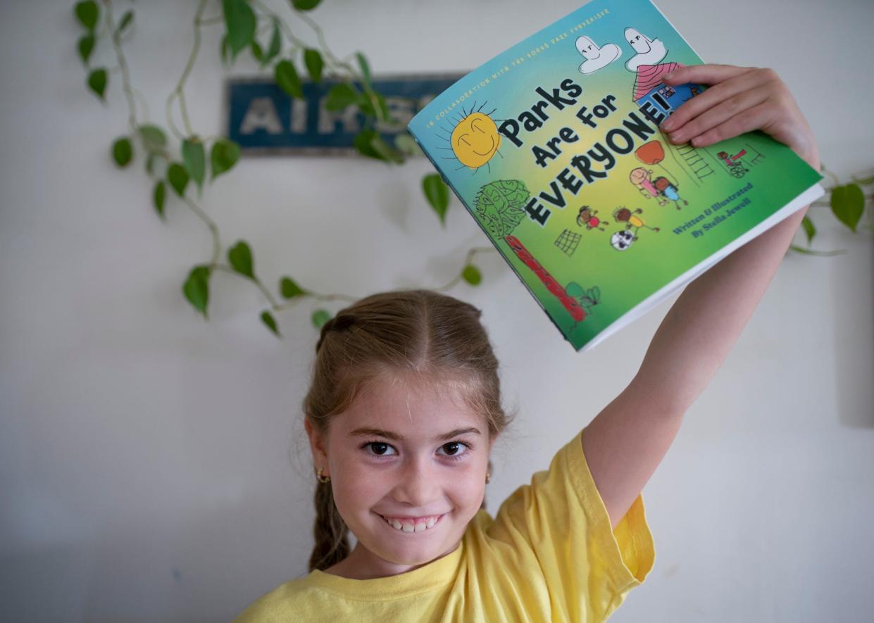 Stella Jewell, 8, shows the book she authored and illustrated titled ÒParks Are For EveryoneÓ on Wednesday, June 28, 2023 at her home in Detroit. The book is JewellÕs contribution to a fundraising effort to create a park for student and community use next to her school the James and Grace Lee Boggs School in Detroit as she heads to third-grade for the next school year.