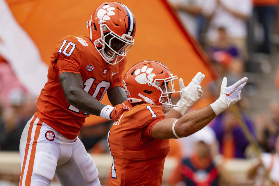Clemson Tigers wide receiver Joseph Ngata (10) celebrates with running back Will Shipley (1) after a touchdown by Shipley in the first quarter during an NCAA college football game against the Furman Paladins in Clemson, S.C., Saturday, Sept. 10, 2022. (AP Photo/Jacob Kupferman)